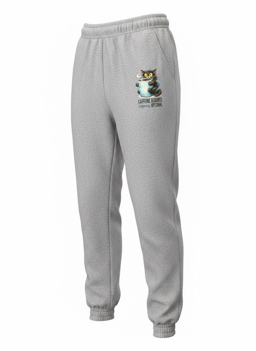 Light gray sweatpants with a small cat graphic and the text 'Caffeine Required Fuzziness Optional' printed on the left thigh.