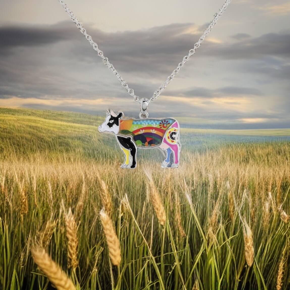 Multi coloured enamel cow necklace with 24" adjustable chain.